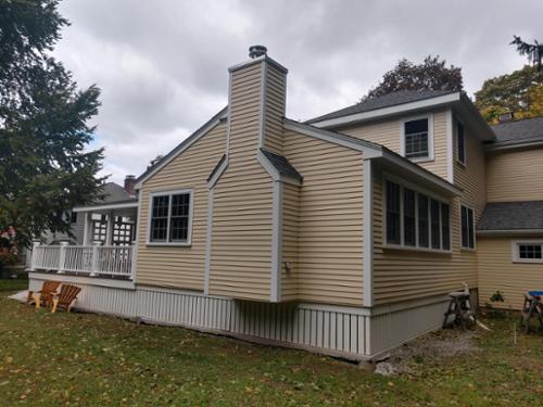 5 window bank on side with built in fireplace.  Vertical privacy lattice made from composite boards with access doors on each end.